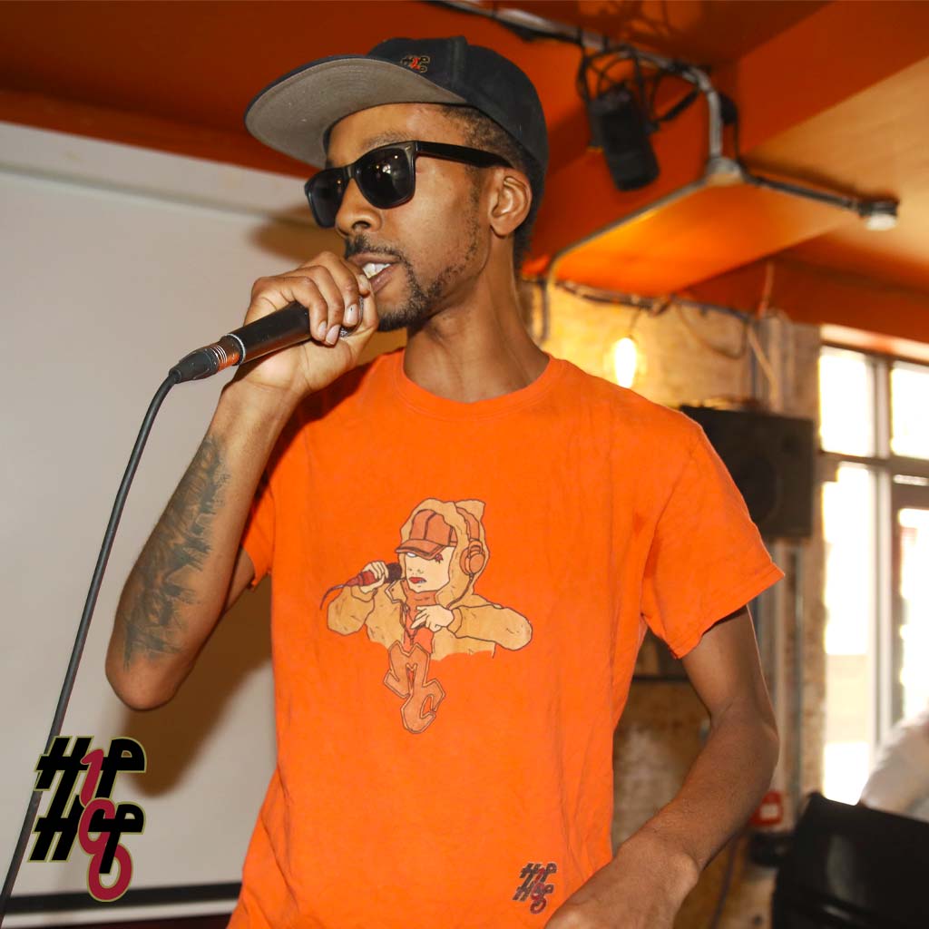 Man on stage wearing T-Shirt